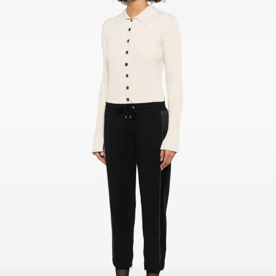 Brunello Cucinelli black jogger trousers shown flat with elastic waistband and tapered cuffs, made from soft fabric for casual comfort.