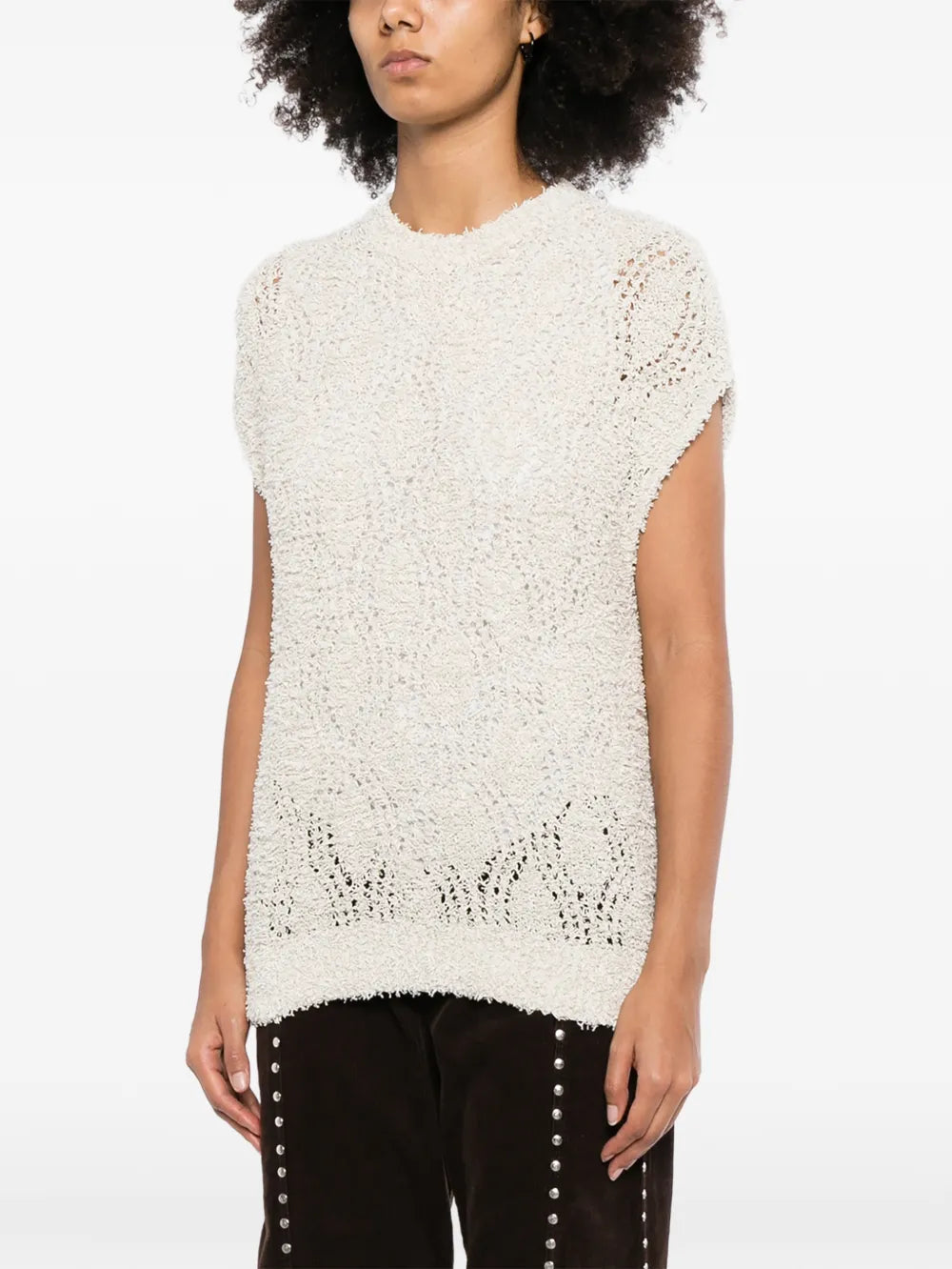 Brunello Cucinelli sleeveless knitted vest in soft beige, close-up of the textured knit fabric and sleeveless design.