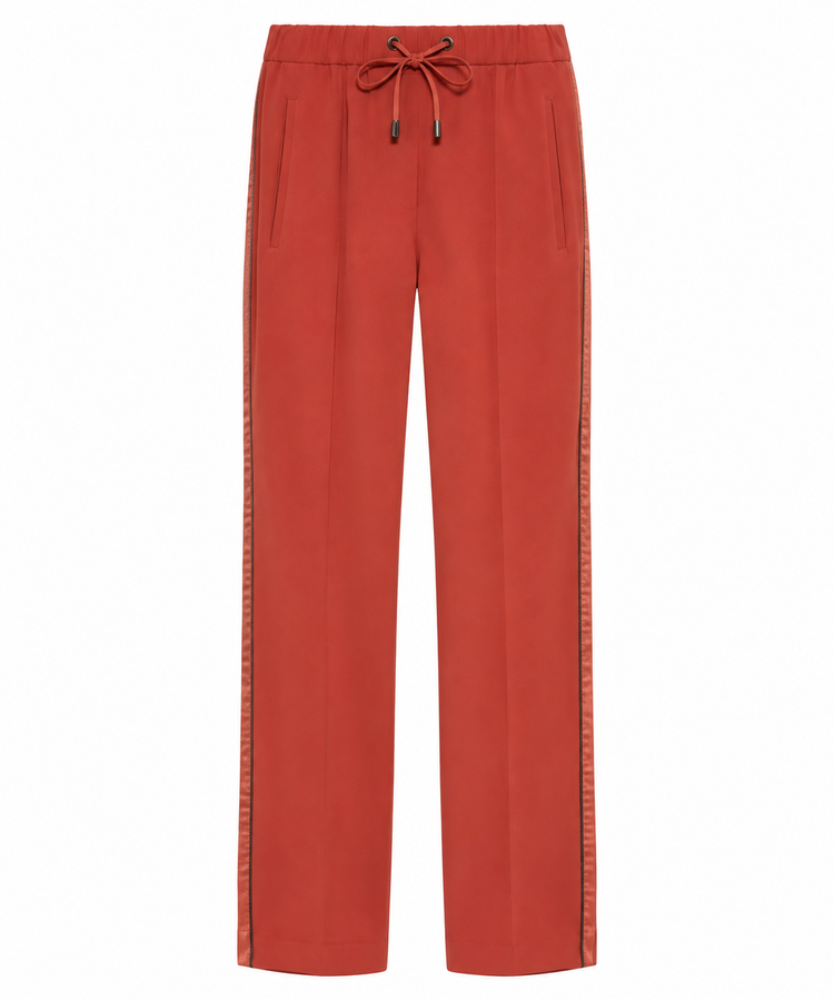 Brunello Cucinelli red drawstring trousers with relaxed fit and elastic waistband, shown hanging against a plain background.