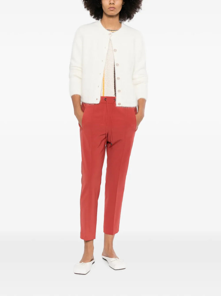 Red Brunello Cucinelli drawstring trousers with a relaxed fit and stylish waistband, shown on a model.