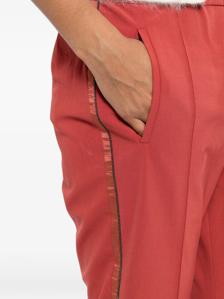 Red Brunello Cucinelli drawstring trousers with a relaxed fit, featuring adjustable waist ties and tailored fabric design.