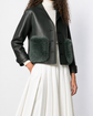 Burberry Prorsum black leather jacket with collar, button-front fastening, cropped silhouette, long sleeves, and oversized fur-trimmed front patch pockets.