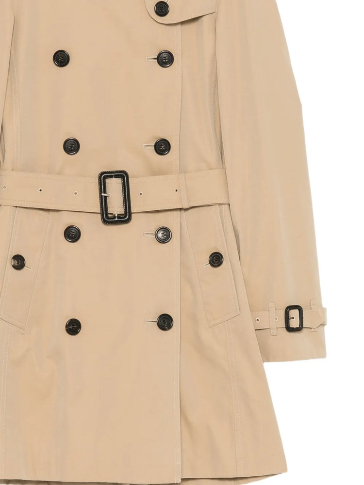 Burberry trench coat displayed on a hanger, classic beige color, double-breasted style with belt and signature check lining.
