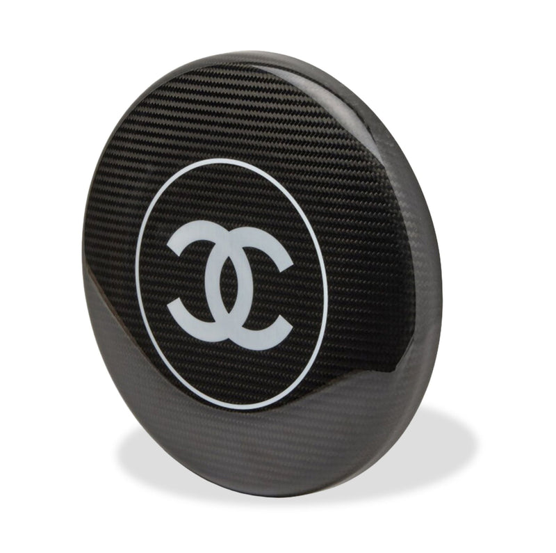 Black Chanel CC frisbee with classic logo design, round plastic object for outdoor play and casual entertainment.