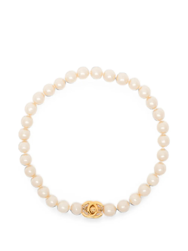 Chanel Coco Turn-Lock choker necklace featuring a pearl and CC logo pendant, stylish jewelry for elegant occasions.