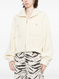 Pre-owned CHANEL tweed jacket with classic pattern, tailored fit, and elegant design, displayed on a hanger.