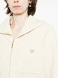 Pre-owned CHANEL tweed jacket with classic pattern, tailored fit, and elegant design, shown on a hanger.