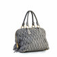 Miu Miu Matelassé tote bag shown from the side, featuring quilted design and elegant structure.
