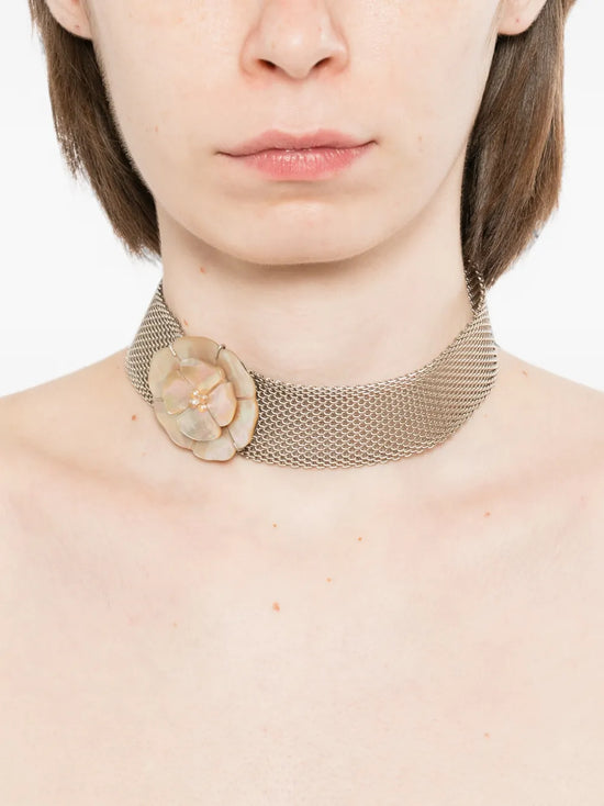 Chanel Camellia Choker Necklace styled on a model, featuring elegant floral design and luxurious jewelry craftsmanship.