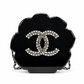 Chanel Camellia Minaudière evening clutch bag with floral design, compact style, and elegant gold-tone hardware.