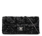 Chanel black sequin East West Flap Bag from 2014–15 with silver-tone CC hardware and leather-interwoven chain shoulder strap.