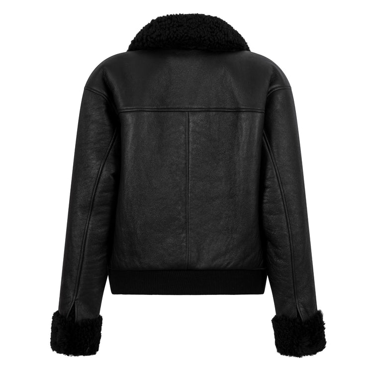 Black leather shearling jacket from Chanel, stylish coat with plush interior, featuring a classic design and luxurious details.