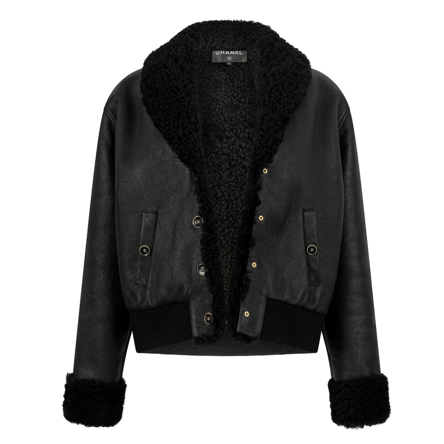 Back view of a black leather shearling Chanel coat, showcasing the luxurious texture and stylish design.