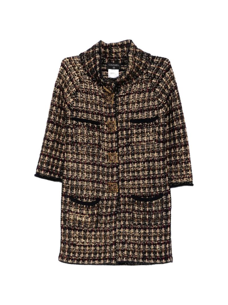 Chanel 2011 Paris Byzance tweed coat displayed on a hanger, featuring classic Chanel style with intricate woven pattern and tailored fit.