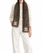 Chanel Orylag and fabric CC scarf, featuring luxurious textured design and classic CC logo, displayed in a stylish fashion setting.
