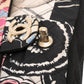 Chanel multicolour quilted patchwork Medium Flap Bag with printed textile panels, gold-tone chain strap, CC turn-lock closure and decorative medallion charm.