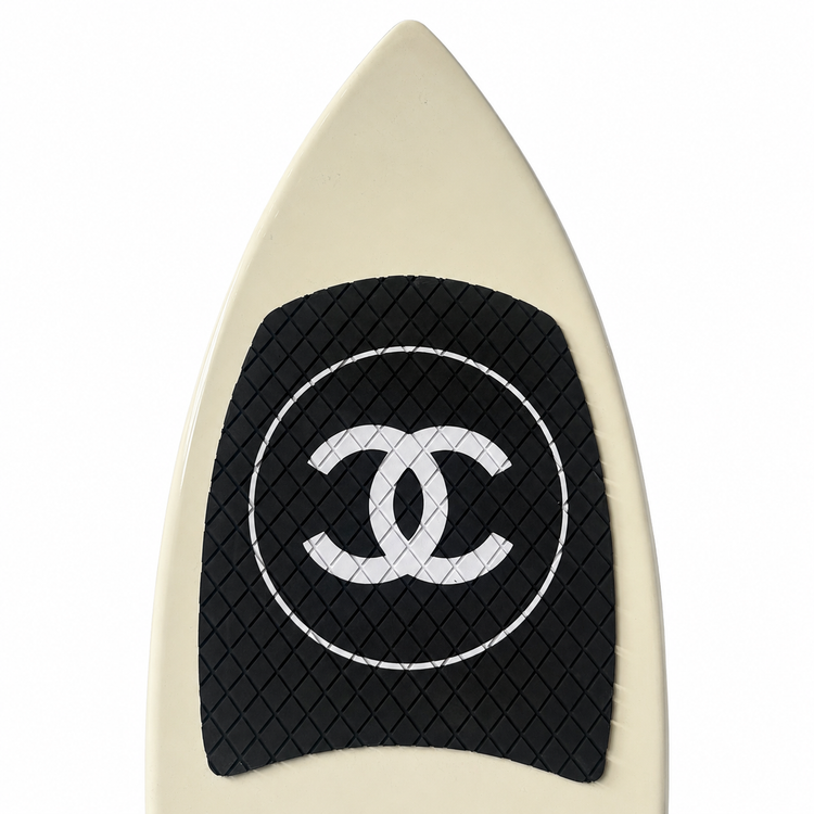 2019 Chanel white and black CC logo wakesurf board with pointed shape, black quilted traction pads, oversized interlocking CC logo, circular Chanel emblem, and collectible luxury board design.