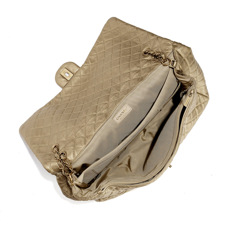 Gold metallic Chanel XXL airline travel flap bag with shoulder strap and interior compartments, stylish and spacious for travel.