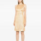 Chanel 1996 sleeveless gold brocade shift dress with intricate woven pattern and elegant silhouette.