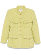 Light green vintage Chanel blazer from 1996, fitted style with classic tailored design, shown on a model.