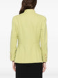 Light green vintage Chanel blazer from 1996, fitted style with classic design, displayed on a hanger.