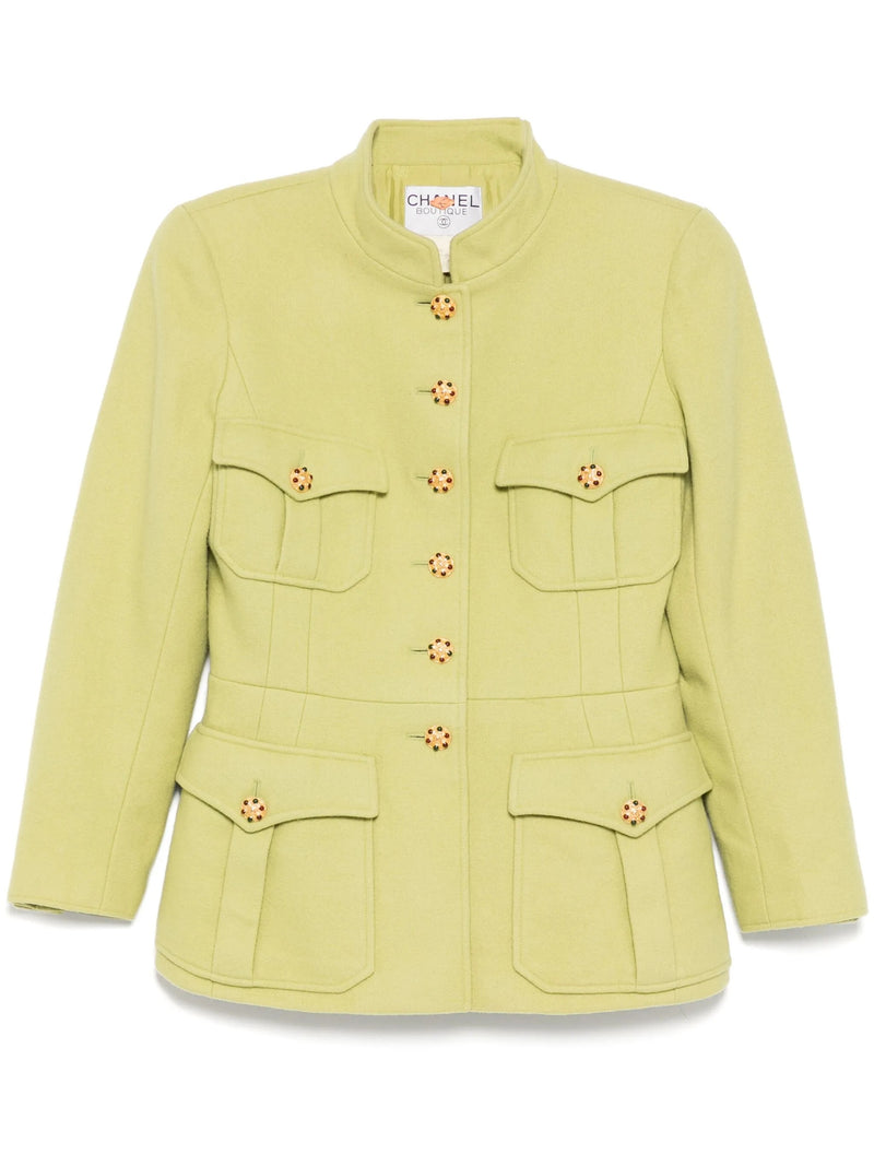 Light green vintage Chanel blazer from 1996, fitted style with classic tailored design, shown on a model.