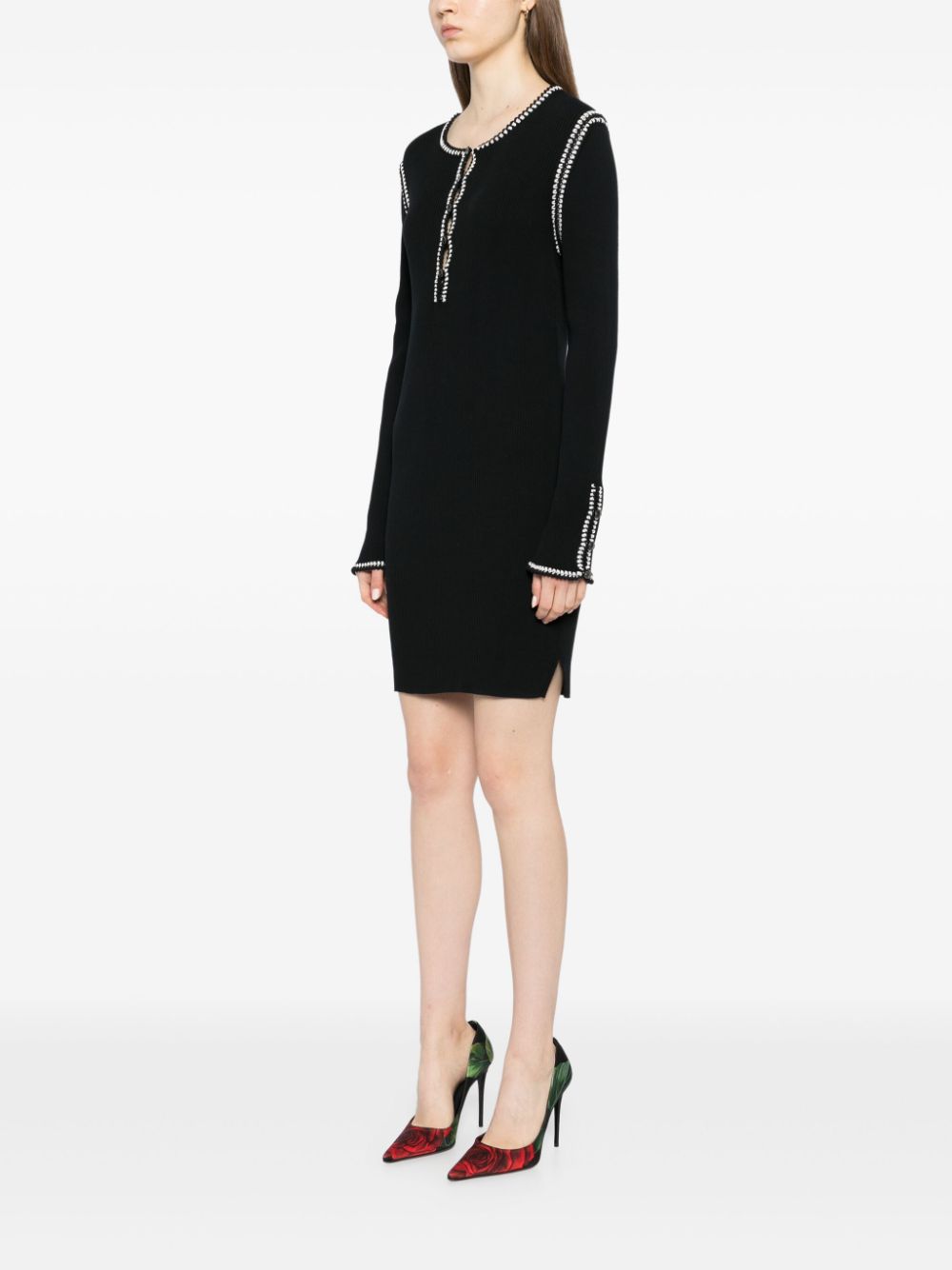 Black Chanel 2002 cotton mini dress with ribbed fabric, stylish and fitted, perfect for casual or semi-formal occasions.
