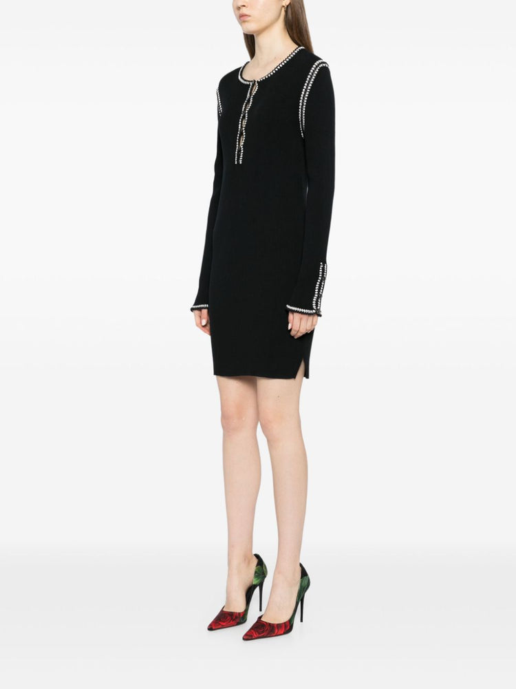 Black Chanel 2002 cotton mini dress with ribbed fabric, stylish and fitted, perfect for casual or semi-formal occasions.