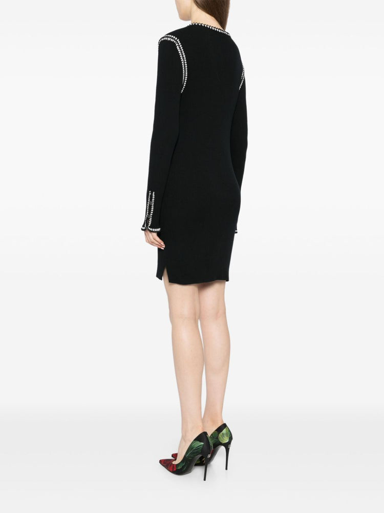 Black Chanel 2002 cotton mini dress with ribbed fabric, sleeveless design, and fitted silhouette.