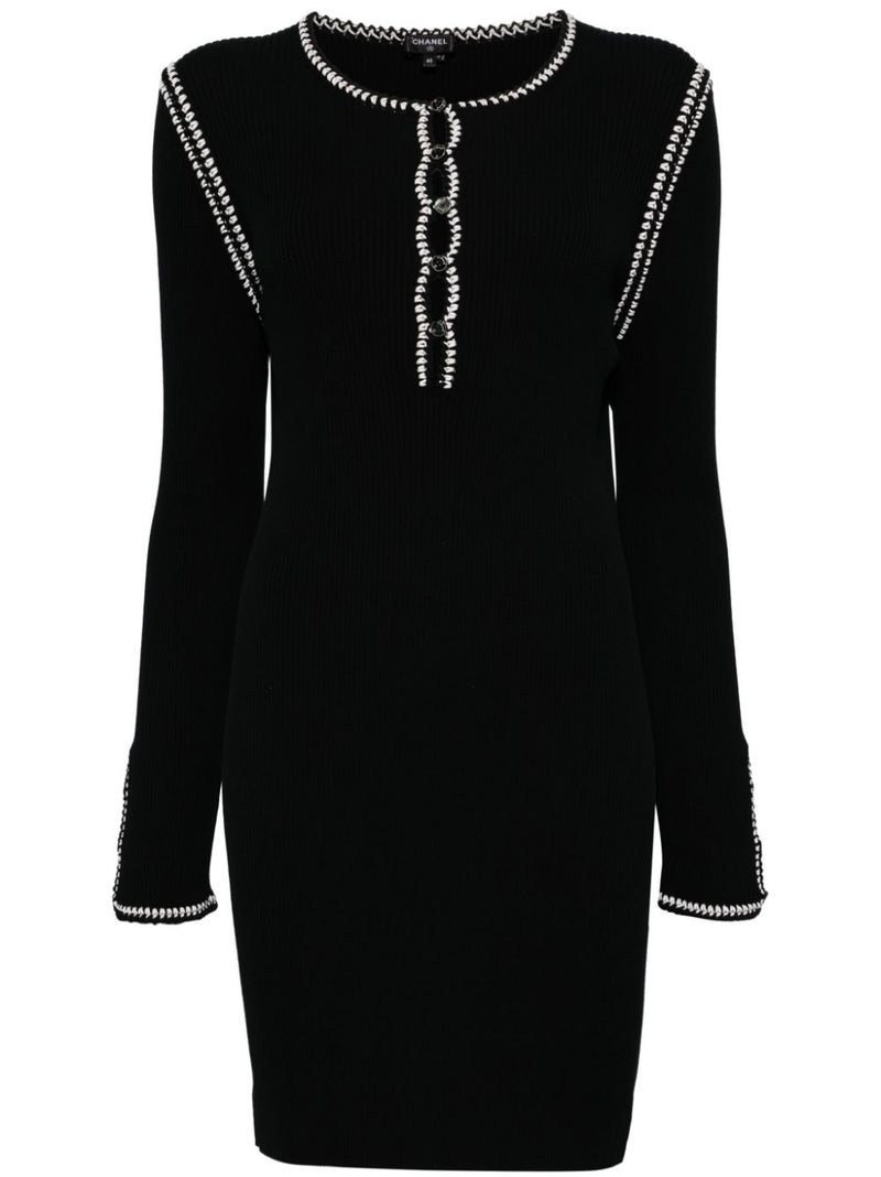 Chanel 2002 black ribbed cotton mini dress with round neckline, long sleeves, contrast white looped trim and decorative front button detailing.