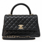 Chanel 2021 Medium Coco Handle Flap Bag in black quilted caviar leather with gold-tone CC hardware, top handle and detachable chain strap.