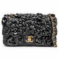 Chanel 2014–2015 black lambskin and patent leather 3D Camellia Flower Medium Flap Bag with gold-tone CC hardware and chain strap.
