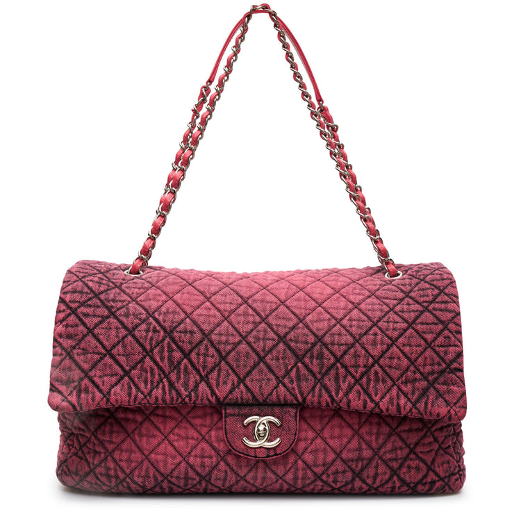 Chanel Airline pink denim XXL flap bag with black graphic quilted pattern, CC turn-lock closure, silver-tone hardware and chain-and-denim shoulder straps.