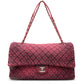Chanel Airline pink denim XXL flap bag with black graphic quilted pattern, CC turn-lock closure, silver-tone hardware and chain-and-denim shoulder straps.