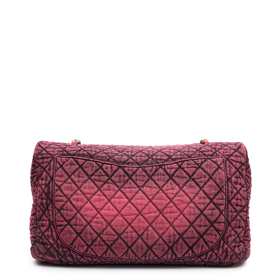 Chanel Airline pink denim XXL flap bag with black graphic quilted pattern, CC turn-lock closure, silver-tone hardware and chain-and-denim shoulder straps.
