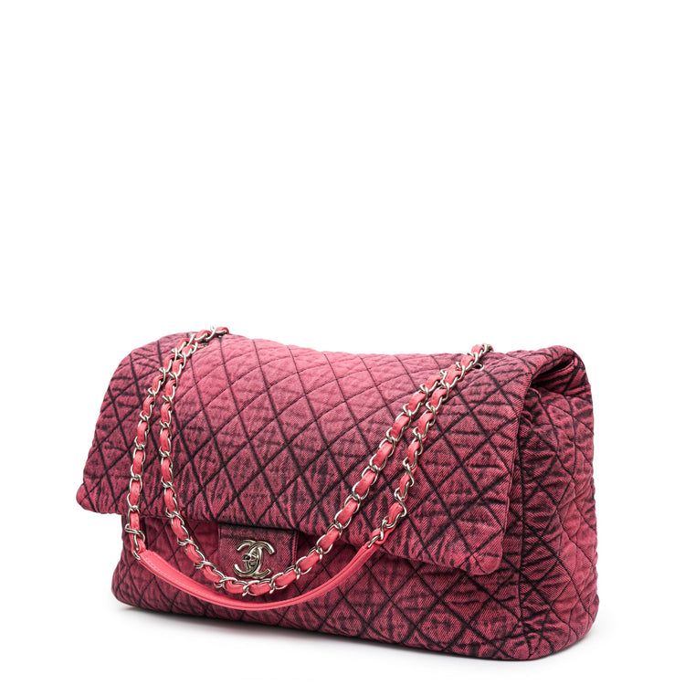 Chanel Airline pink denim XXL flap bag with black graphic quilted pattern, CC turn-lock closure, silver-tone hardware and chain-and-denim shoulder straps.