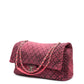 Chanel Airline pink denim XXL flap bag with black graphic quilted pattern, CC turn-lock closure, silver-tone hardware and chain-and-denim shoulder straps.