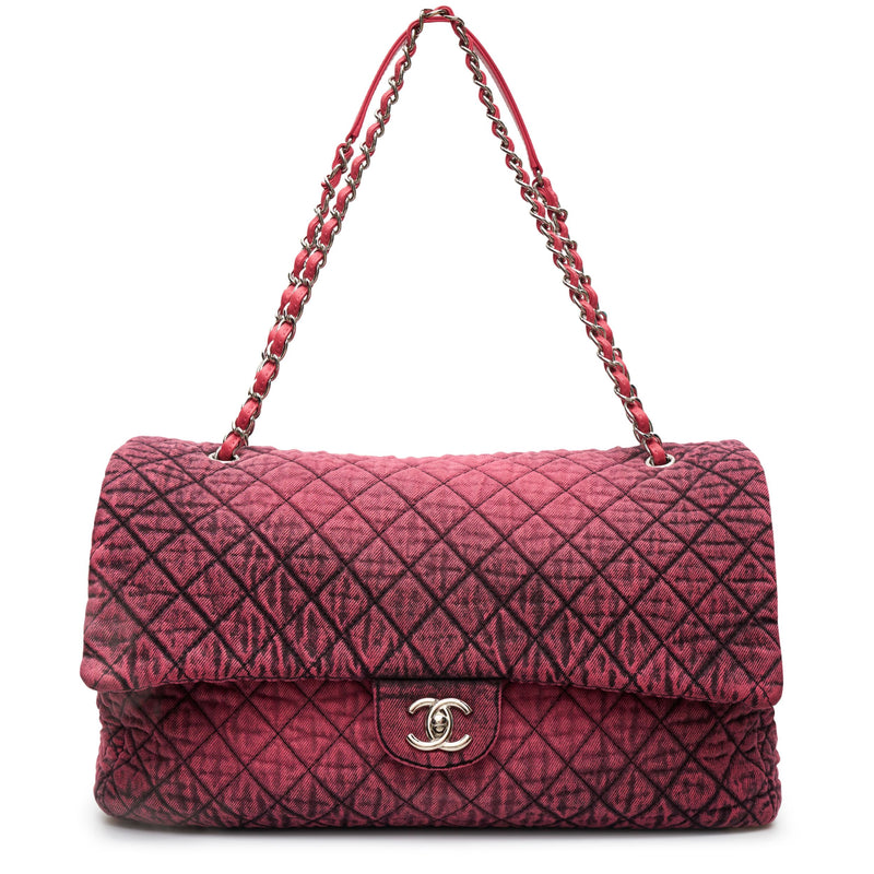 Chanel Airline pink denim XXL flap bag with black graphic quilted pattern, CC turn-lock closure, silver-tone hardware and chain-and-denim shoulder straps.