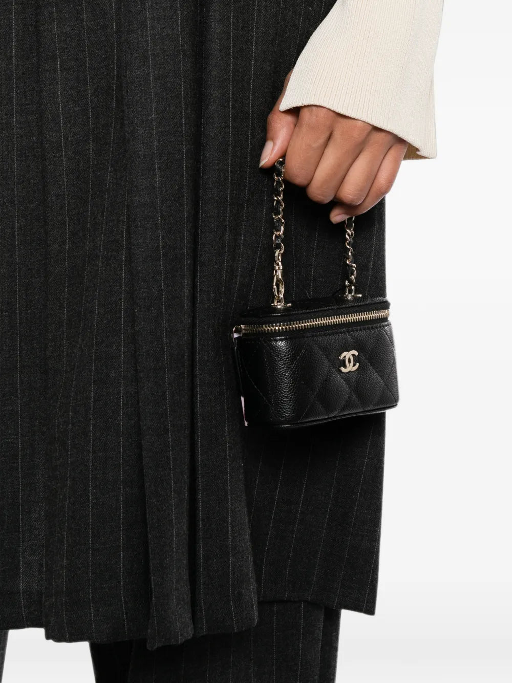 Chanel quilted caviar mini vanity bag charm with silver hardware, featuring a textured quilted design and logo accents.