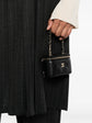 Chanel quilted caviar mini vanity bag charm with silver hardware, featuring a textured quilted design and logo accents.