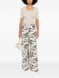 Pre-owned beige Chanel cashmere top, soft and cozy, featuring a classic design and elegant fit.