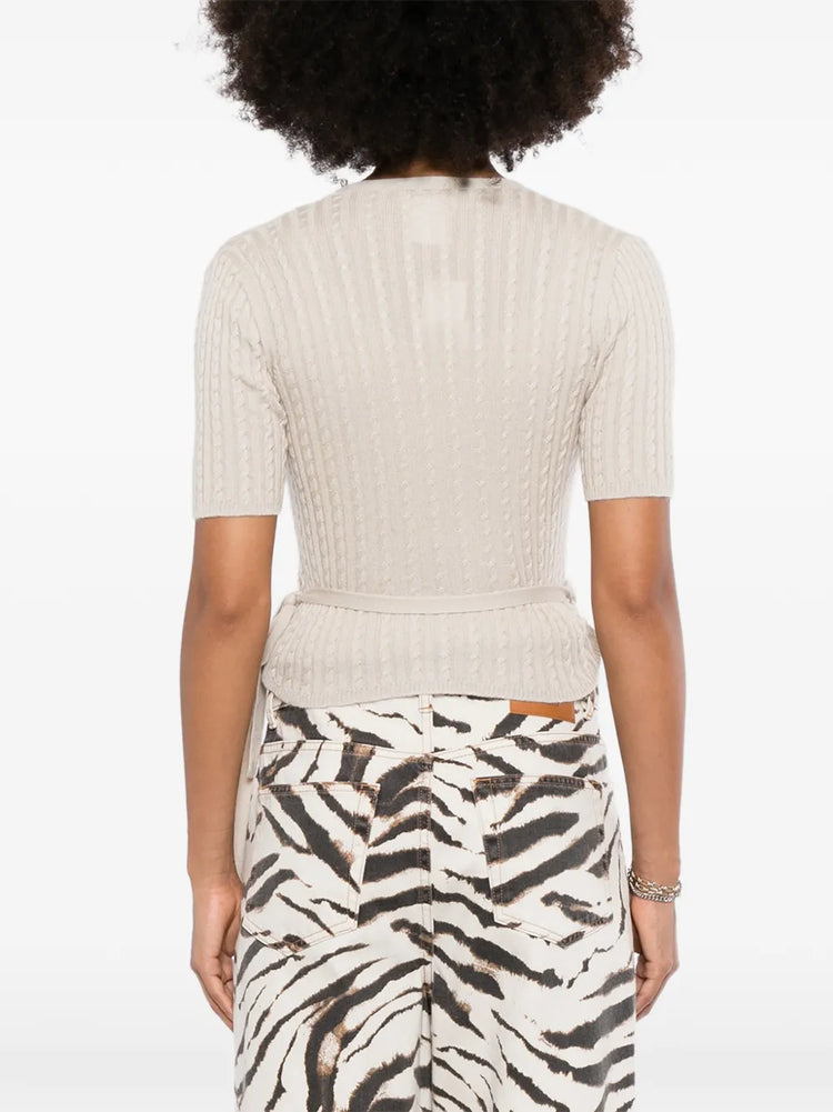 Back view of a beige Chanel pre-owned cashmere top, showcasing its soft fabric and elegant design.
