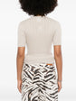 Back view of a beige Chanel pre-owned cashmere top, showcasing its soft fabric and elegant design.