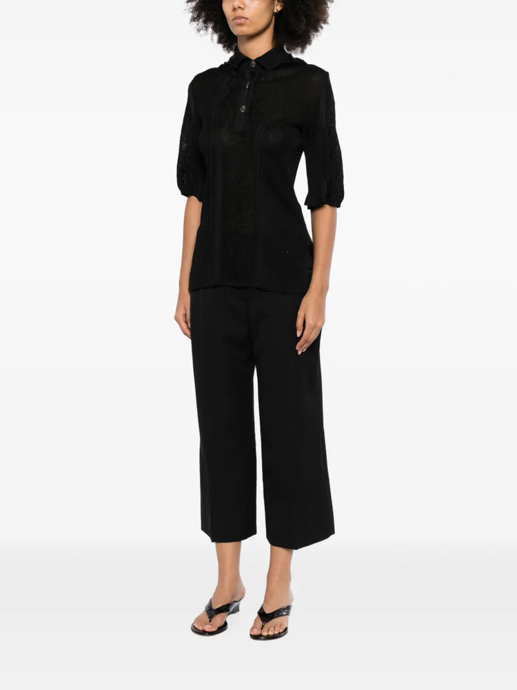 Black Chanel lace-panel polo top with a hood, featuring intricate lace details and a stylish, casual design.