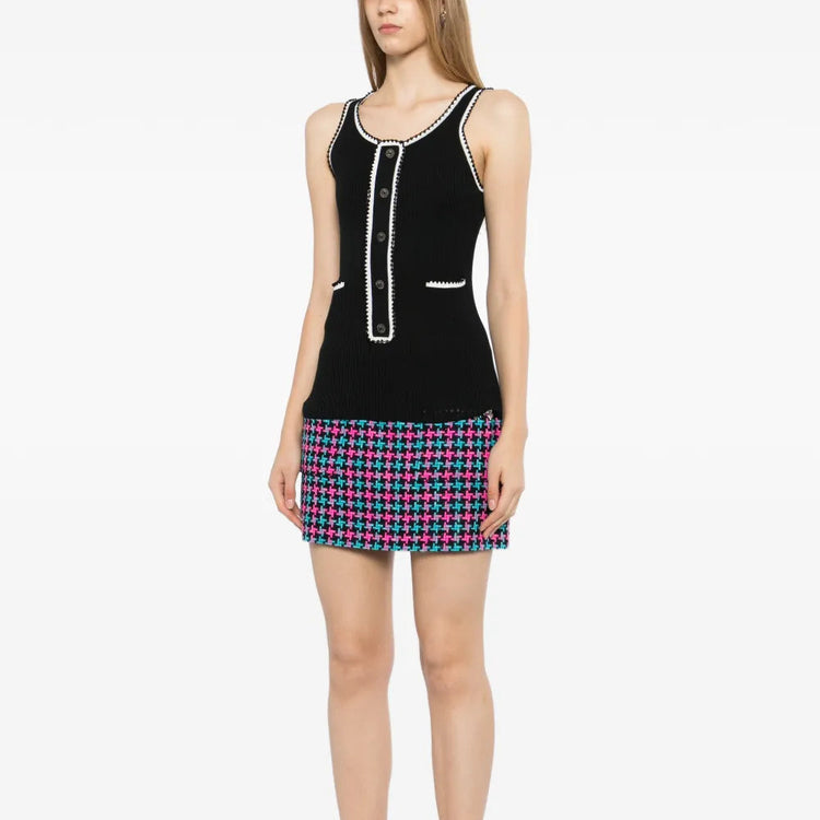 Black ribbed knit contrast tank top by Chanel, showcasing a close-up of the fitted, sleeveless design with textured fabric.