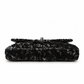 Black Chanel sequin east-west flap shoulder bag with gold chain strap and front flap design.