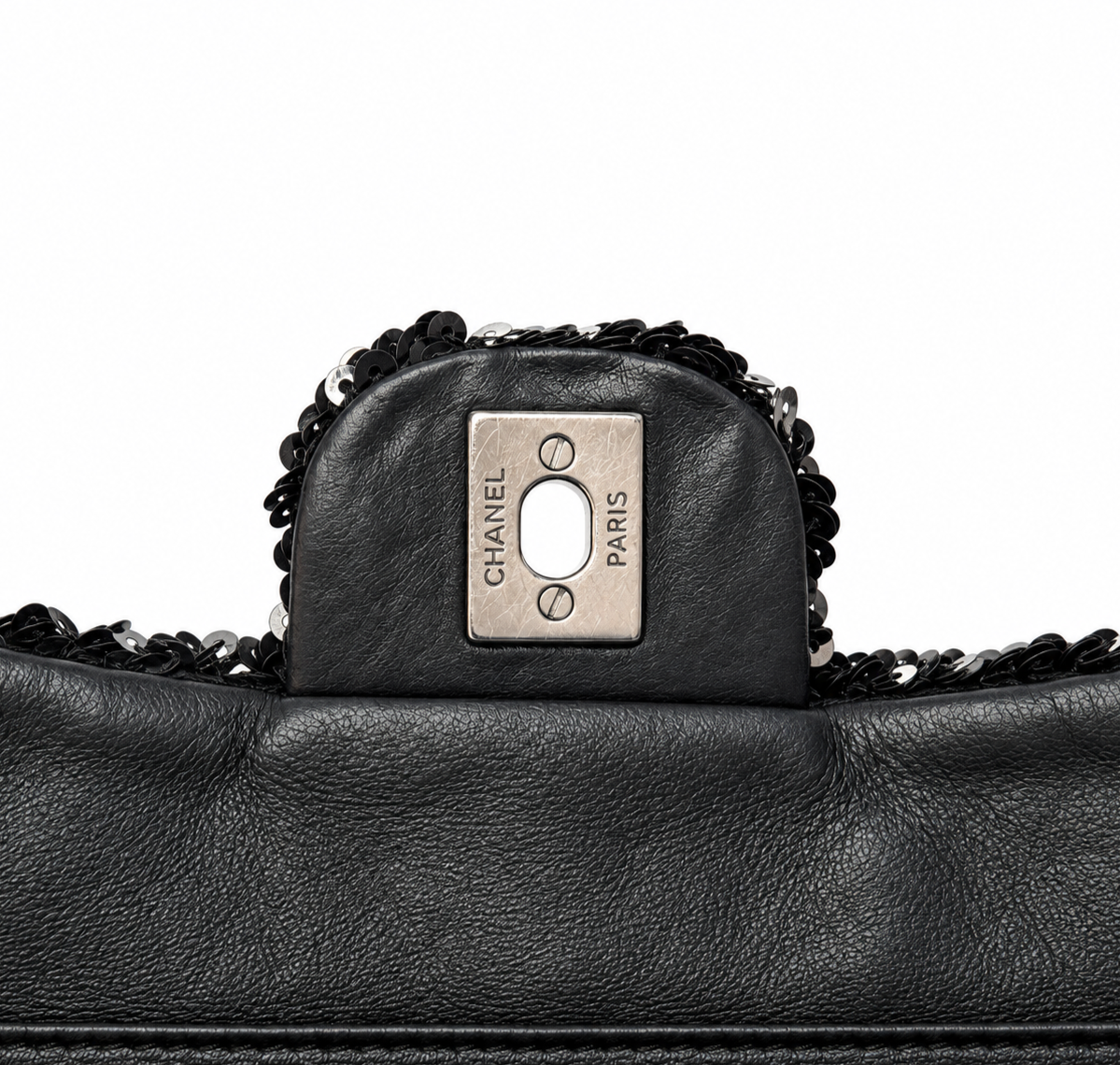 Black Chanel sequin East West flap shoulder bag with gold-tone hardware and chain strap, stylish evening accessory.
