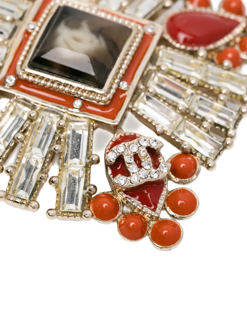 Chanel Crystals and Red Stones CC Brooch featuring sparkling crystals and vibrant red stones on a elegant brooch design.