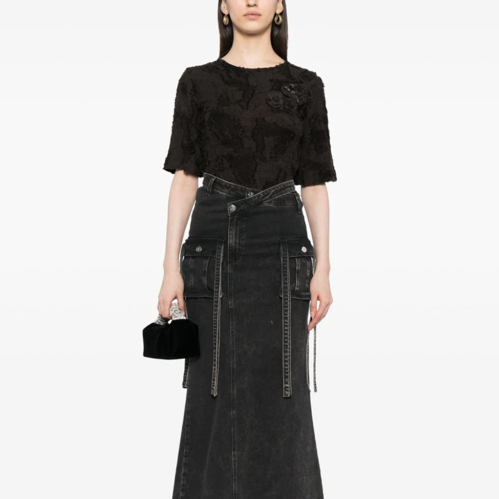 Detail of camellia appliqué on Chanel black cotton top