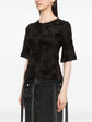 Chanel black cotton top with brooches, side view